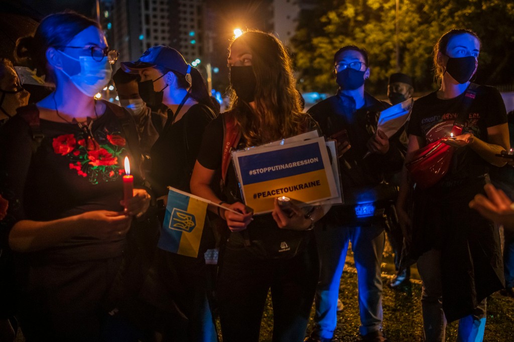 People hold candles during a protest against the massive military operation by Russia against Ukraine, in front of the Russian Embassy in Kuala Lumpur on February 25, 2022. - The Malaysian Insight pic by Seth Akmal.